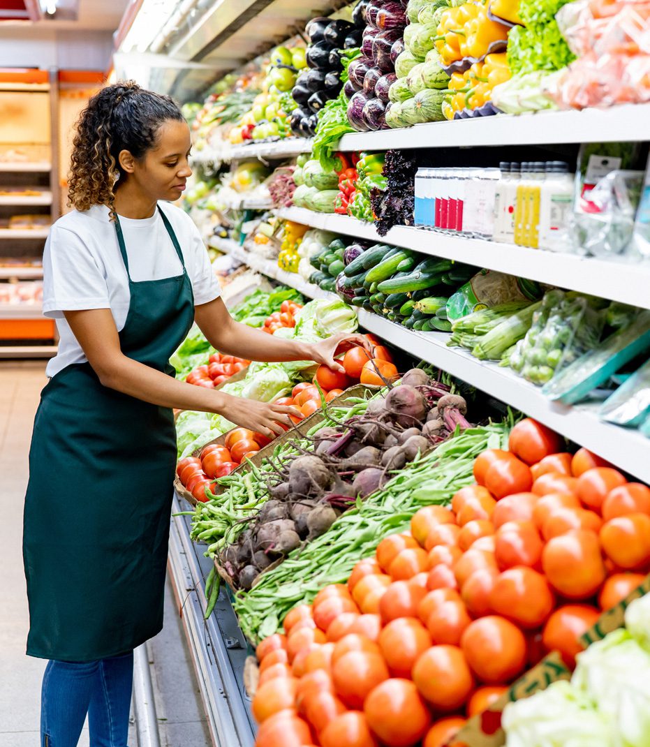 Store-associate-organizing-produce-to-prevent-retail-accident