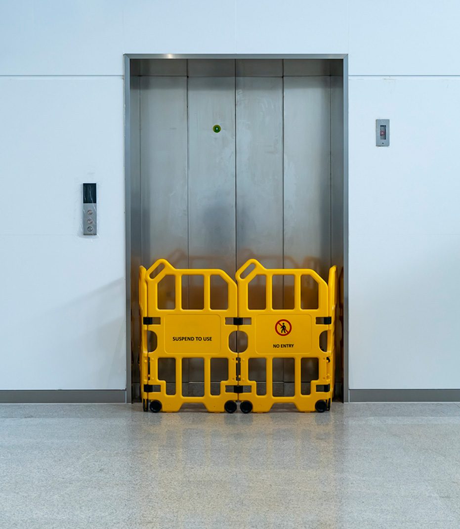 Yellow-fence-blocking-elevator-entry-to-prevent-accident