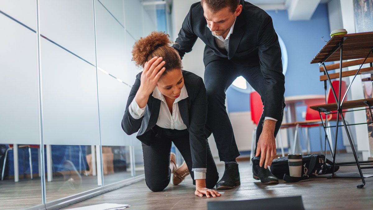 Businesswoman-falling-while-dropping-papers-in-office