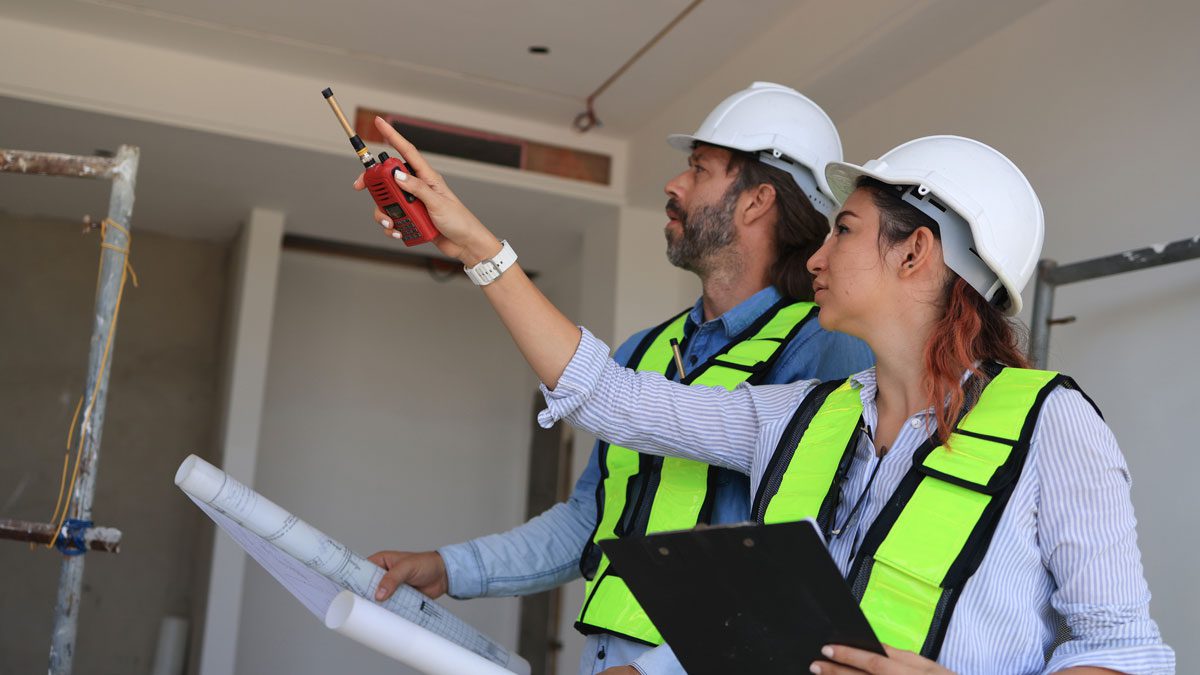 Construction-engineers-inspecting-houses-on-site