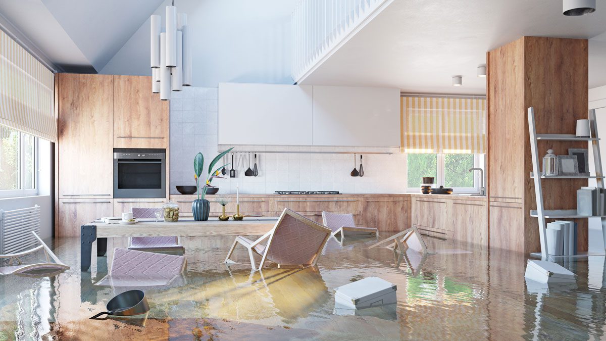 Flooded kitchen with water damage and overturned furniture