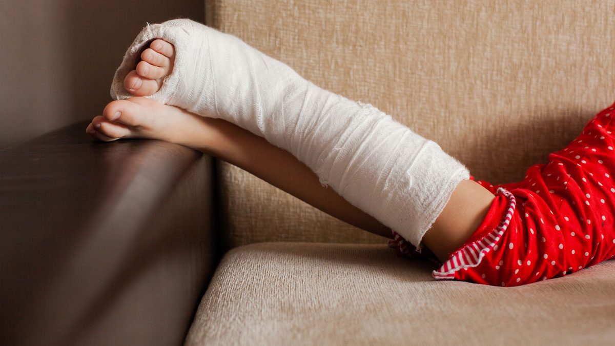 Girl-lying-on-sofa-with-leg-in-cast