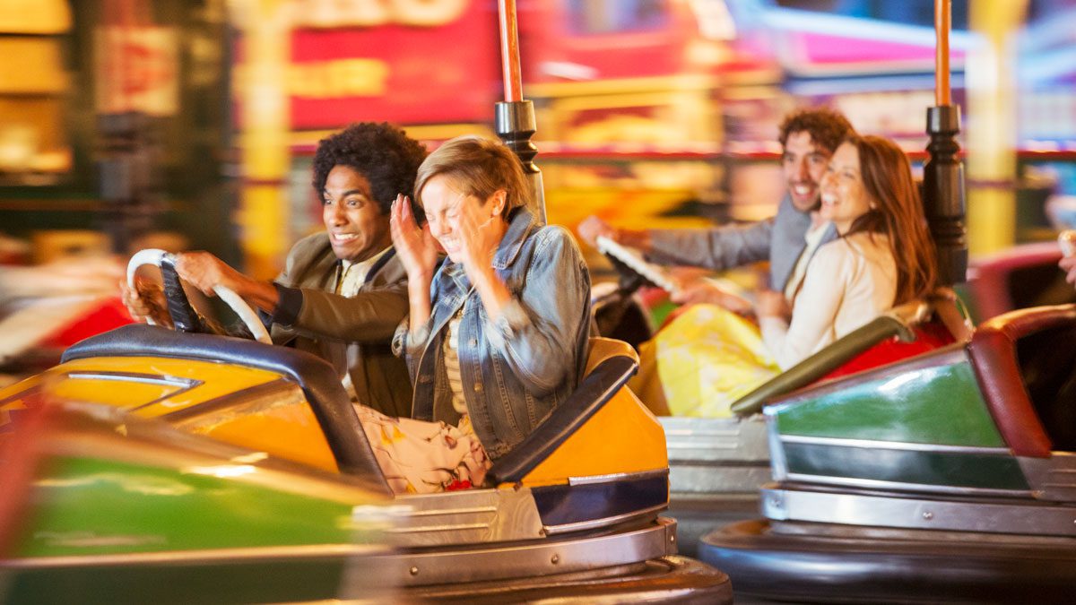 Group-of-friends-riding-bumper-cars-at-amusement-park