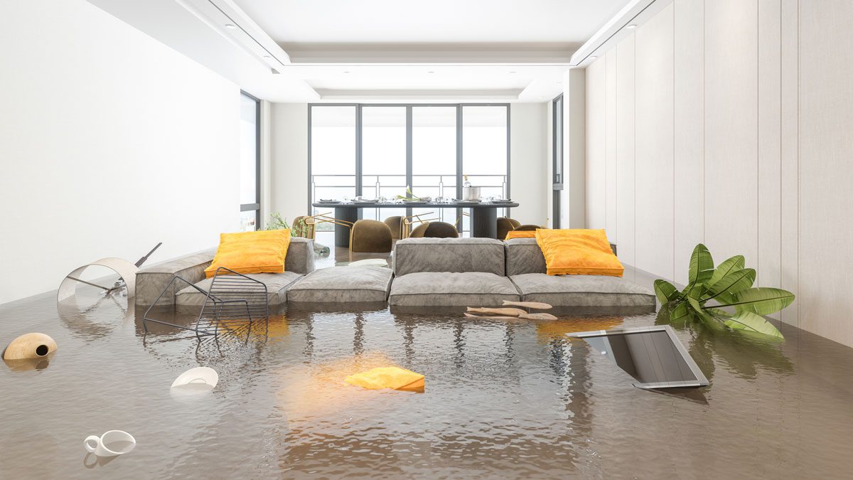 Living room flooded with water damaging furniture and belongings