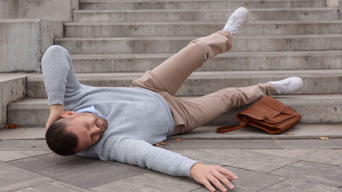 Man fallen on stairs clutching head