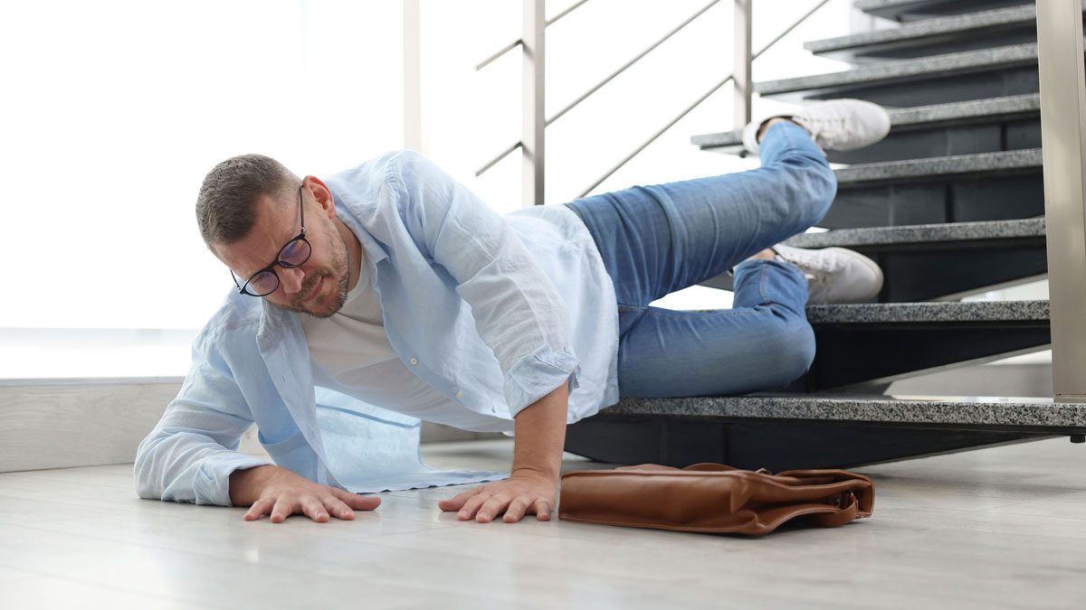 Man-lying-on-stairs-after-fall