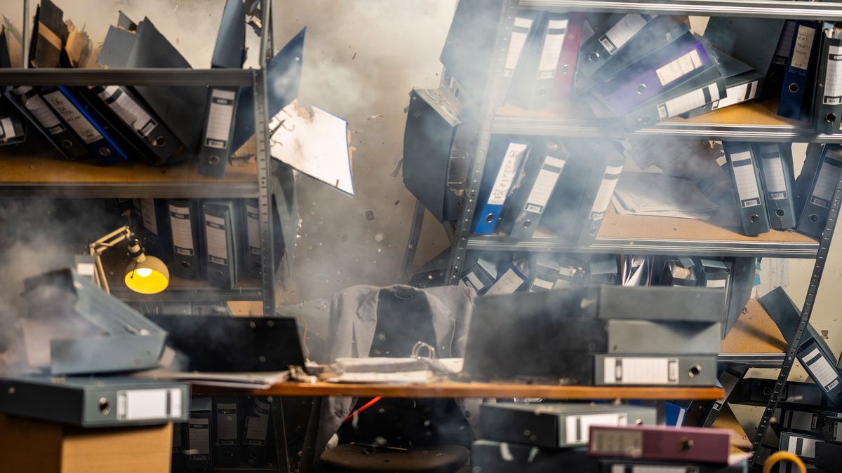 Office shelves collapsing with files scattering during structural damage