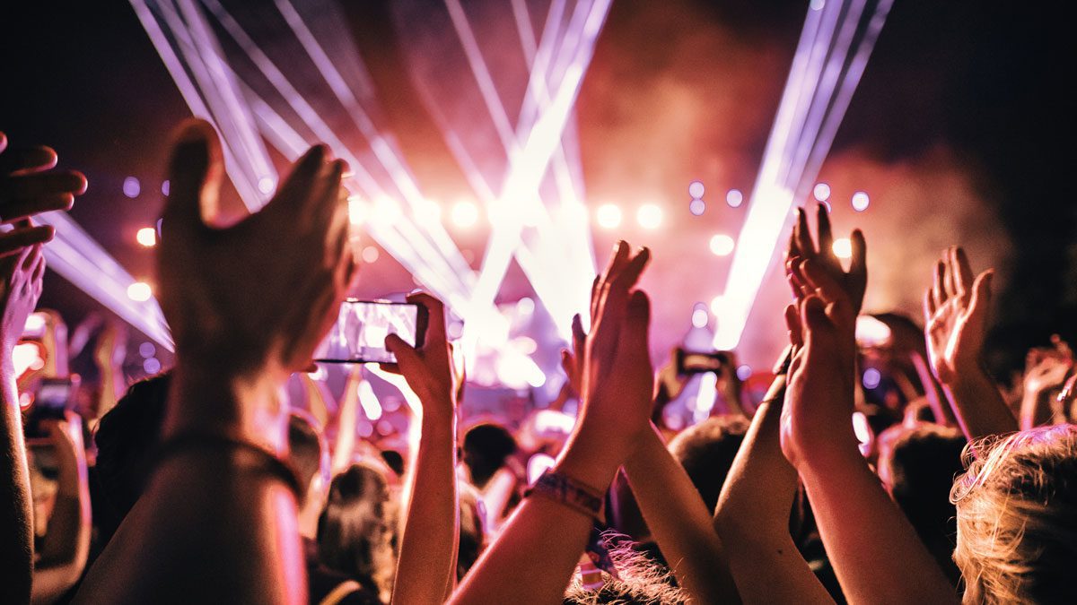 People-dancing-with-raised-hands-at-nightclub-party
