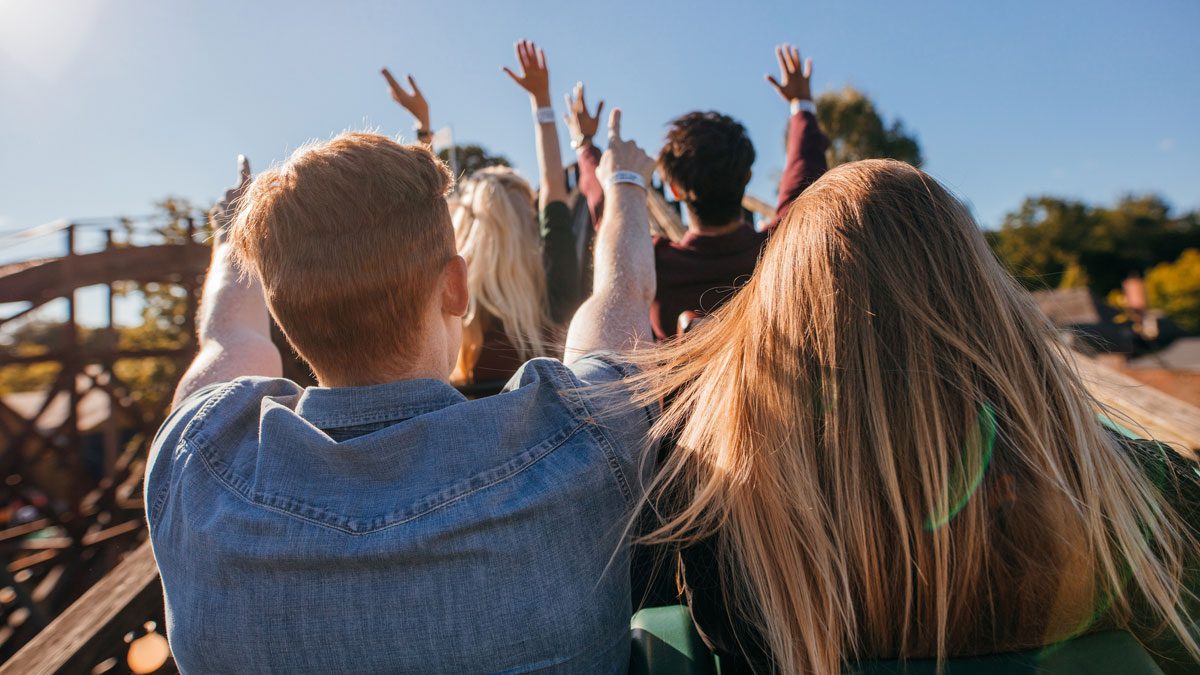 People-riding-roller-coaster-with-raised-hands