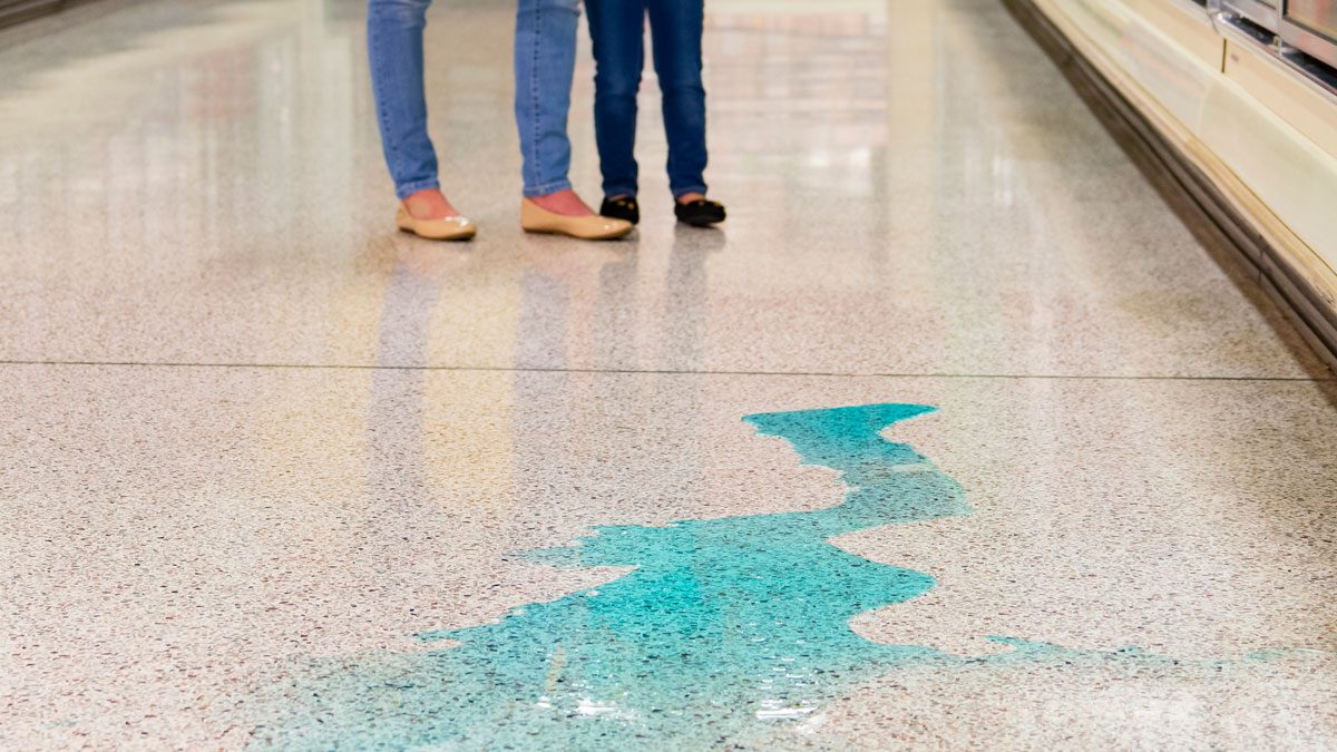Spilled liquid on grocery store floor creating slip hazard