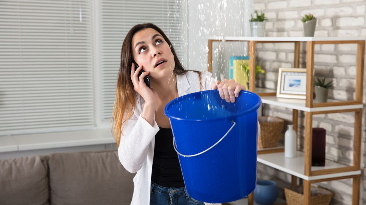 Woman-on-phone-calling-plumber-for-water-leak
