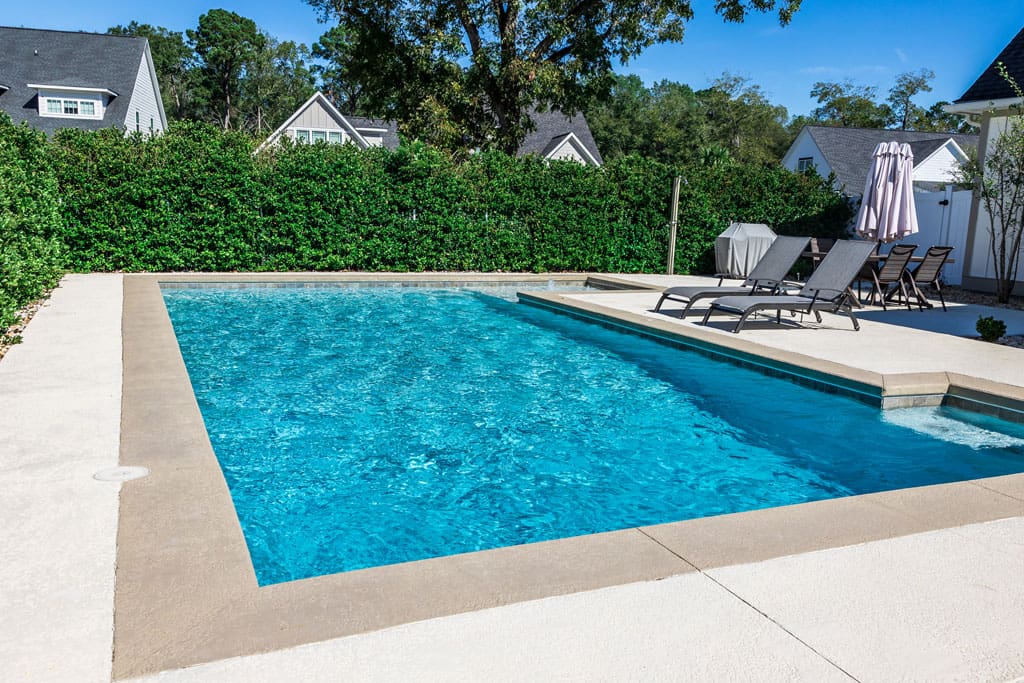 backyard-swimming-pool-behind-a-residential-home